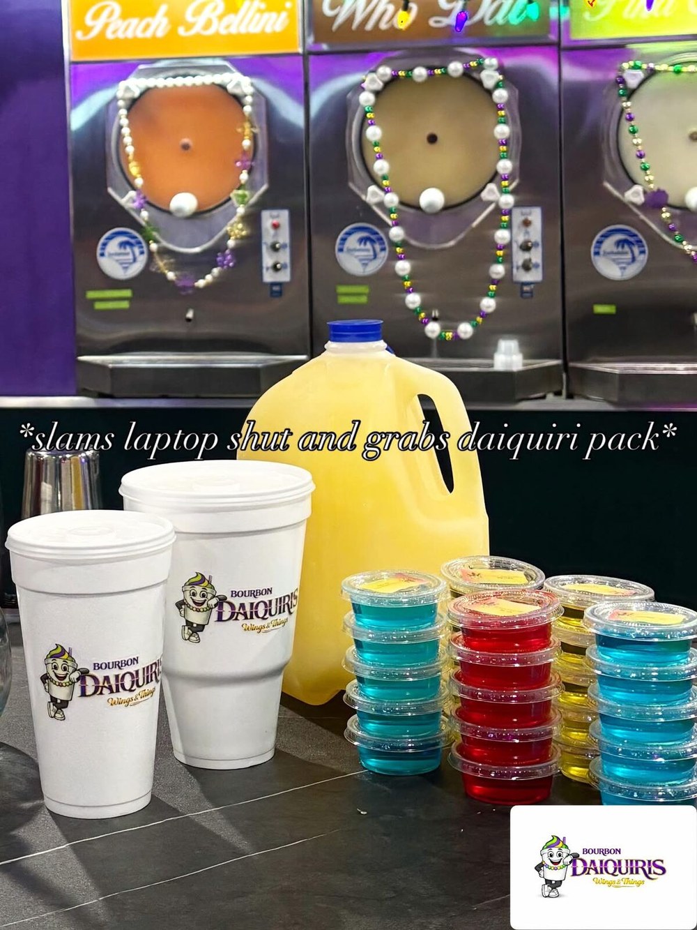 A daiquiri pack: branded cups, a jug, and stacks of jello shots in front of the machines